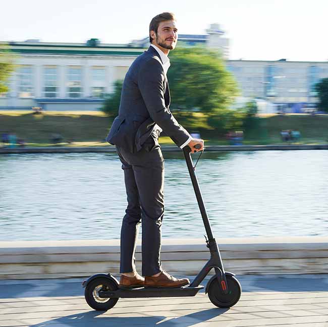 man riding electric scooter