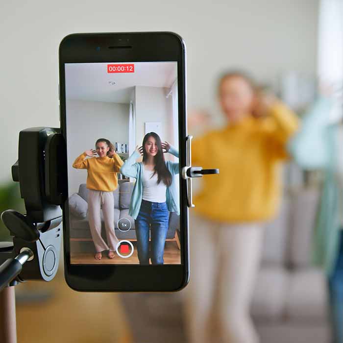 Two girls filming a TikTok video