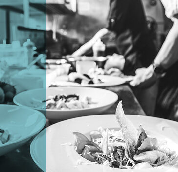 chef plating up food in a restaurant kitchen