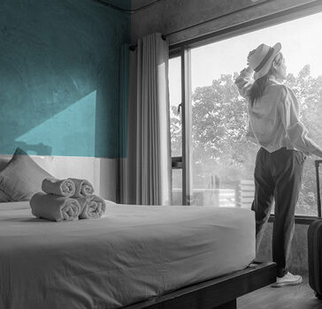 Woman looking out of hotel window